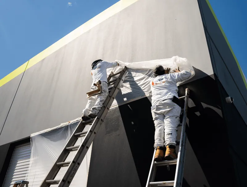 Color Drop painters coating a commercial warehouse exterior in Las Vegas