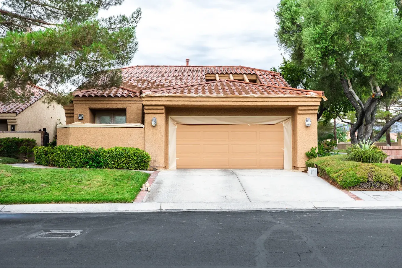 Las Vegas home masked and prepped with a freshly coated stucco exterior and garage